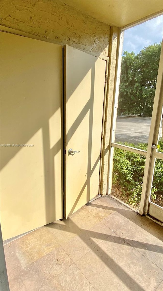 unfurnished sunroom featuring plenty of natural light