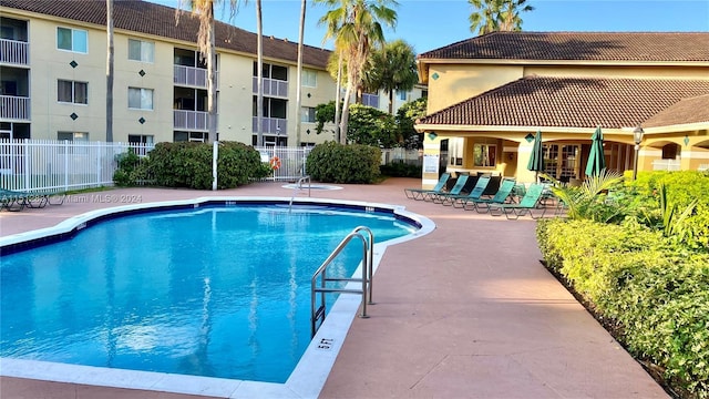 view of swimming pool with a patio area