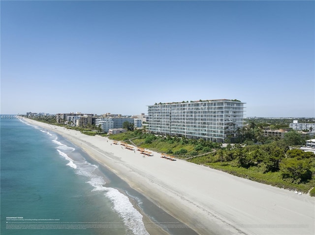 exterior space with a water view and a view of the beach