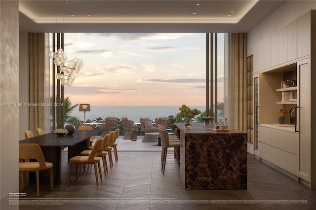 dining room with tile patterned floors and a water view