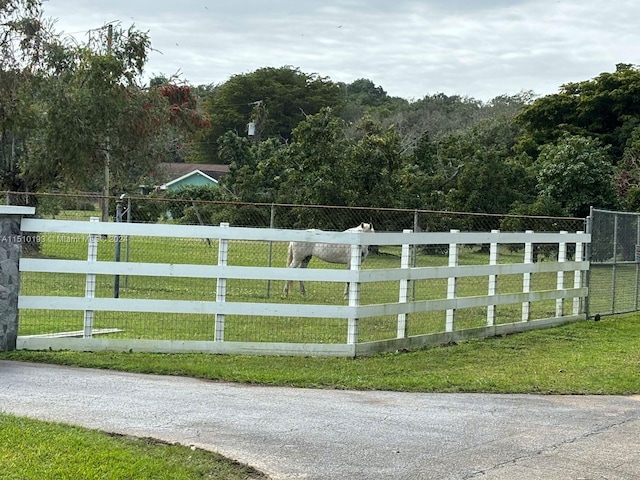 view of gate with a yard