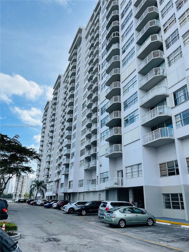 view of building exterior with uncovered parking