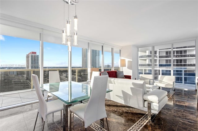 dining space with floor to ceiling windows and dark tile floors