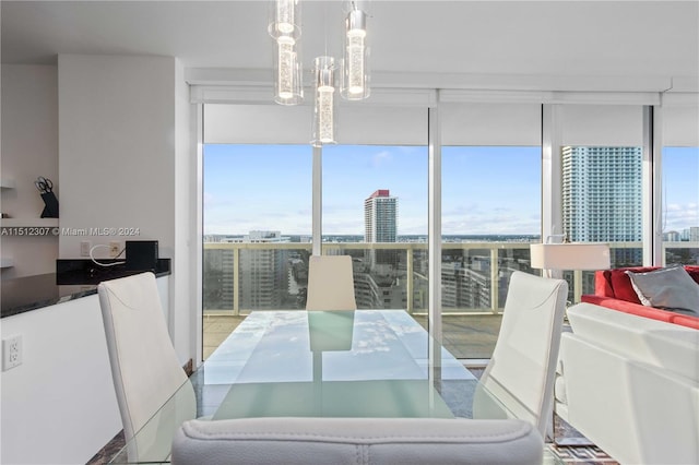 tiled dining space with a notable chandelier and expansive windows