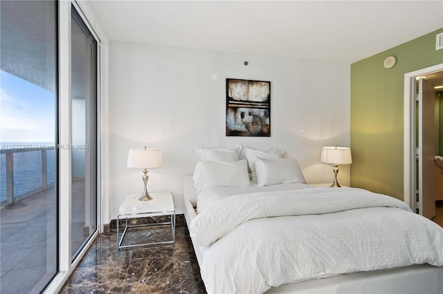 tiled bedroom with floor to ceiling windows and a water view