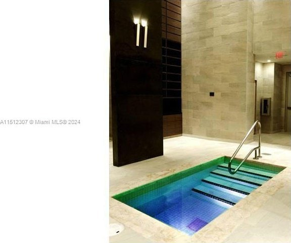 view of pool with elevator