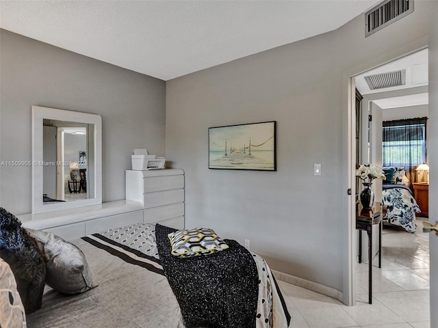 tiled bedroom with a textured ceiling