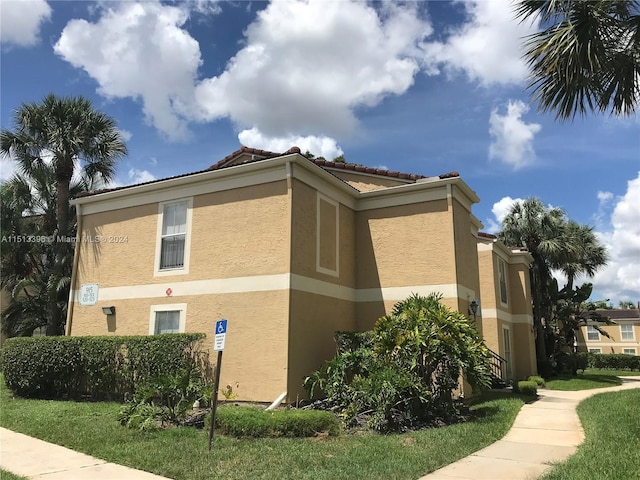 view of side of property with a yard