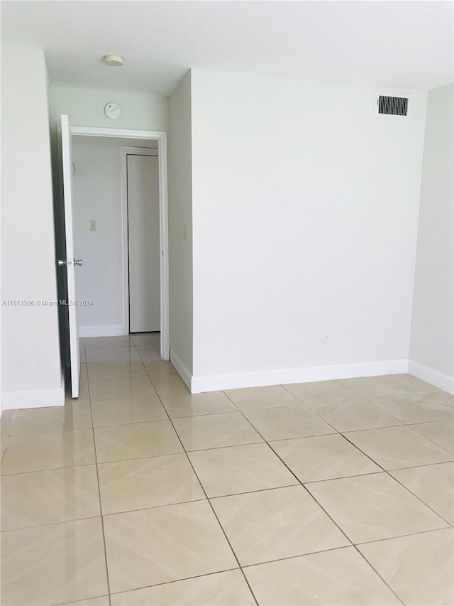 unfurnished room with light tile flooring