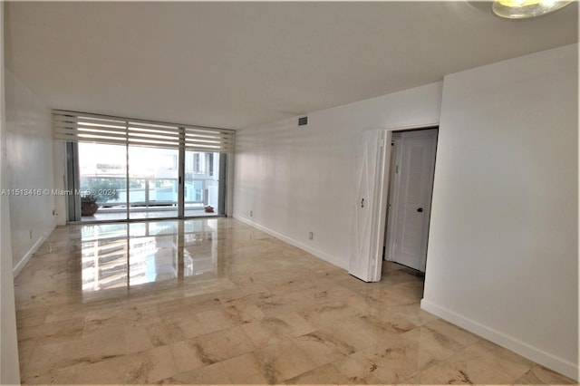 empty room featuring floor to ceiling windows