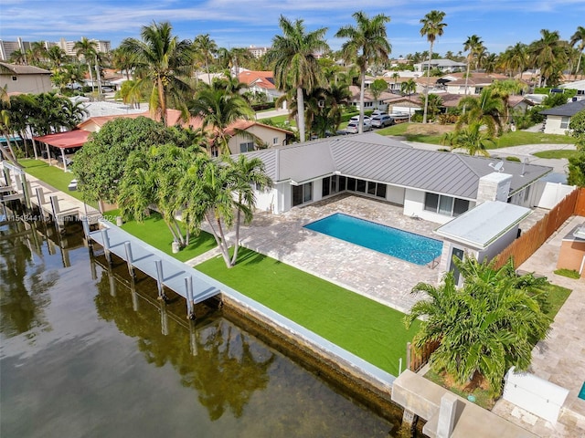 exterior space with a patio area, a dock, and a water view