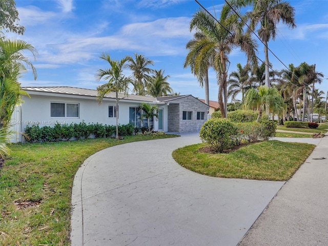 ranch-style home featuring a front yard