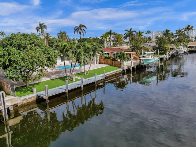 dock area with a yard and a water view