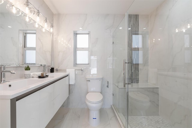 bathroom with vanity, toilet, tile walls, and a shower with door