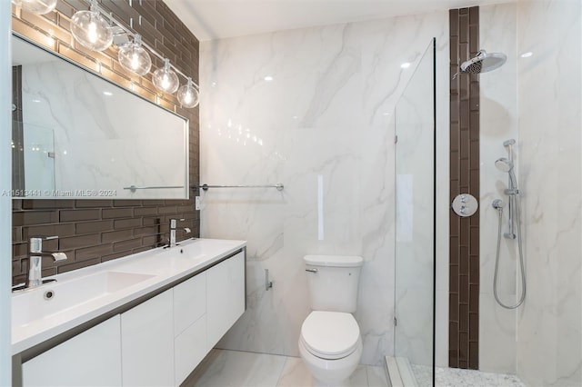 bathroom featuring vanity, toilet, tile walls, and tiled shower