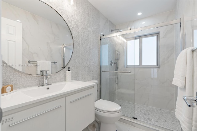 bathroom featuring vanity, toilet, and an enclosed shower