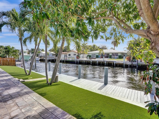 dock area with a yard and a water view