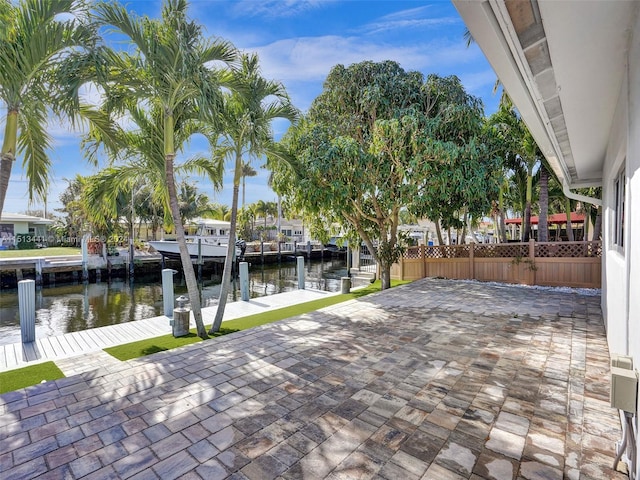 view of patio featuring a water view and a boat dock