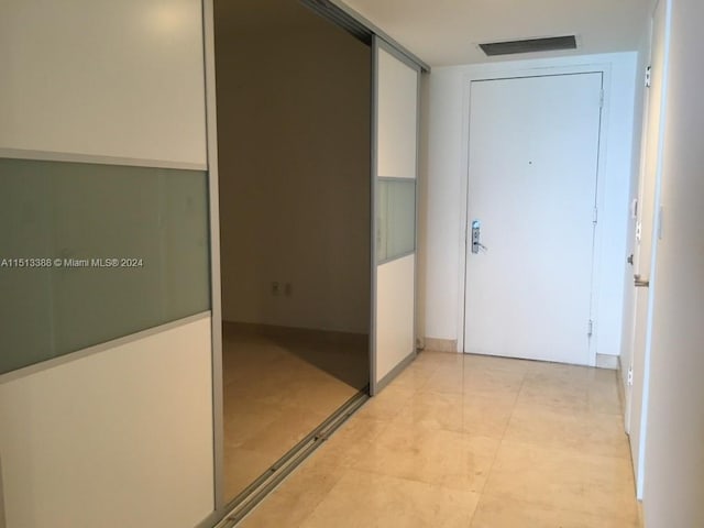 hallway featuring light tile floors