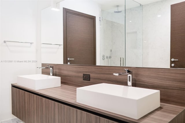 bathroom featuring vanity and a shower with shower door