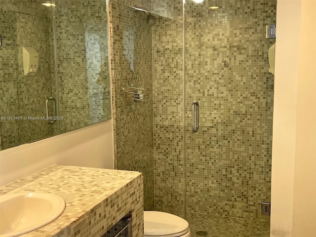 bathroom with vanity, an enclosed shower, and toilet