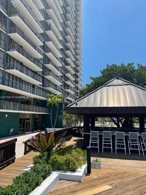 view of property's community featuring a gazebo and exterior bar