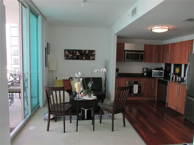 dining area featuring hardwood / wood-style flooring and floor to ceiling windows