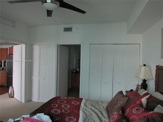 bedroom with stainless steel refrigerator and ceiling fan