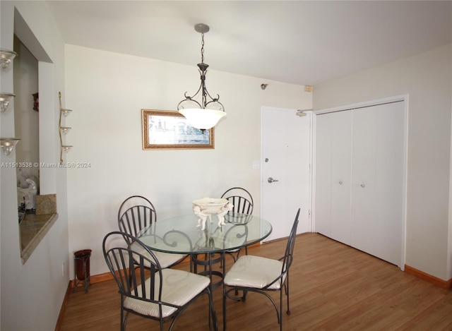 dining space with hardwood / wood-style floors