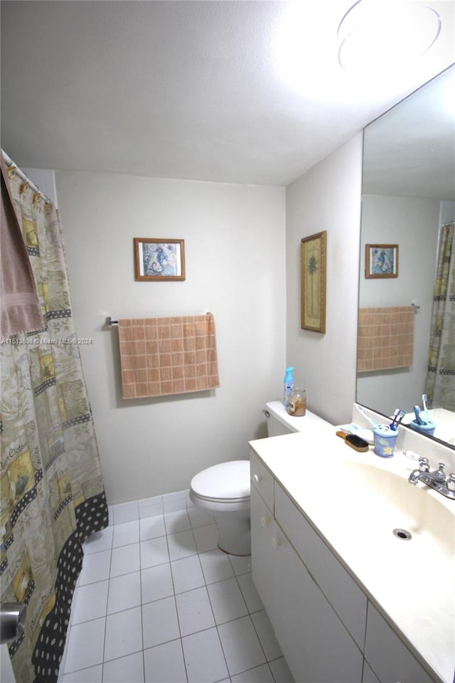 bathroom with vanity, toilet, and tile patterned floors