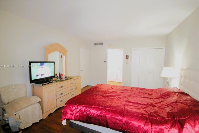 bedroom with dark hardwood / wood-style flooring