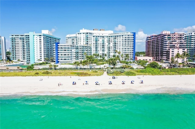 drone / aerial view featuring a water view and a view of the beach