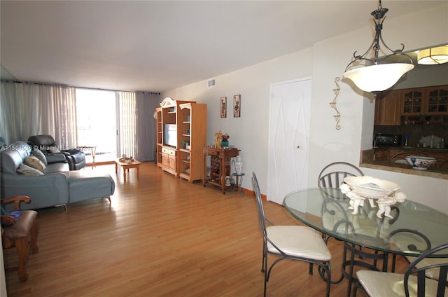 dining space featuring wood-type flooring