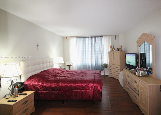 bedroom with dark hardwood / wood-style flooring