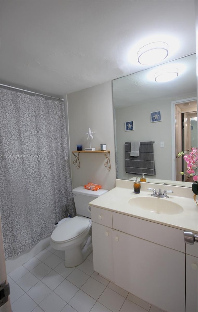 bathroom featuring a shower with shower curtain, tile patterned flooring, vanity, and toilet