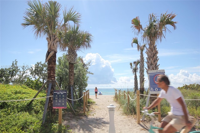 view of home's community featuring a water view and a view of the beach