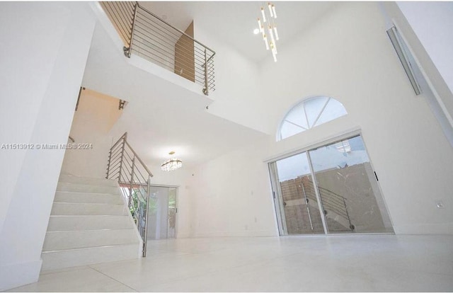 interior space with an inviting chandelier and a towering ceiling