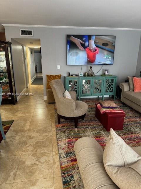 tiled living room featuring ornamental molding