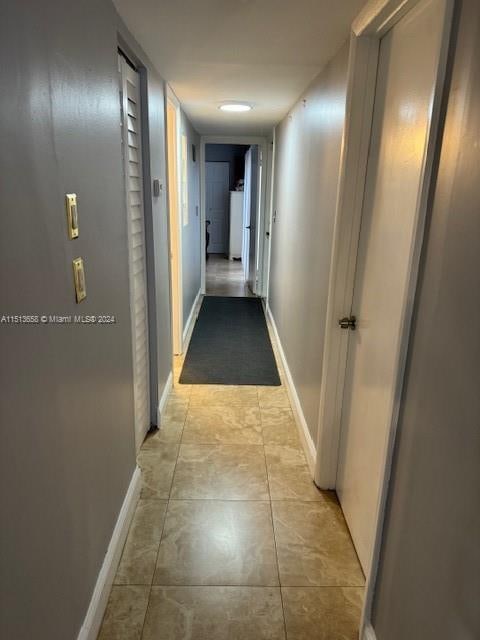 hallway featuring light tile patterned floors