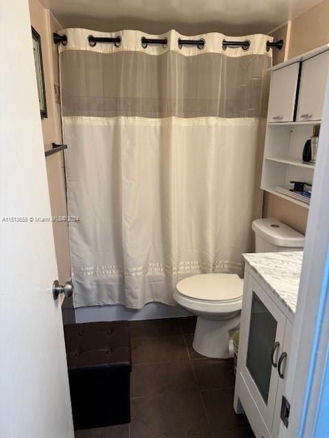 full bathroom with tile patterned flooring, vanity, shower / tub combo with curtain, and toilet