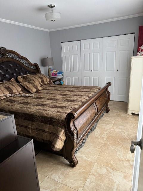 bedroom with ornamental molding and a closet