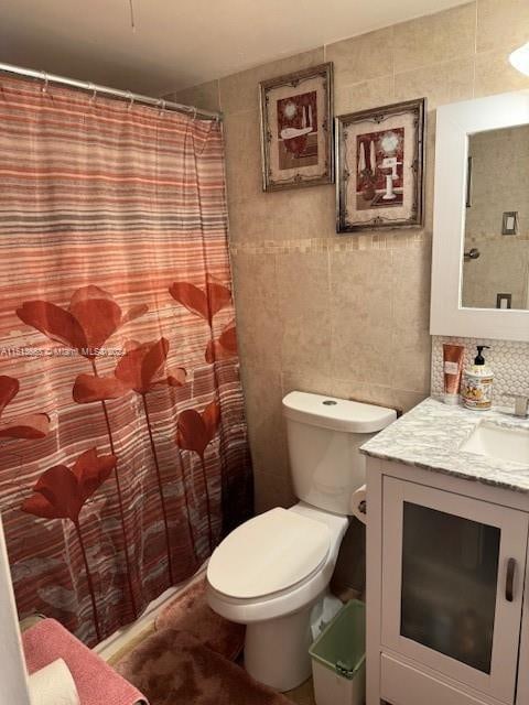 bathroom featuring tile walls, tasteful backsplash, toilet, and vanity