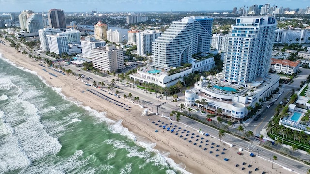 drone / aerial view featuring a view of the beach and a water view