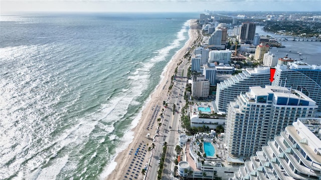 birds eye view of property with a water view and a view of the beach