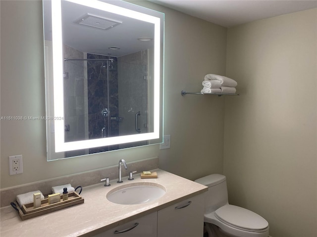 bathroom featuring vanity, toilet, and tiled shower