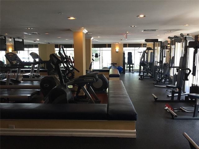 gym featuring ornate columns