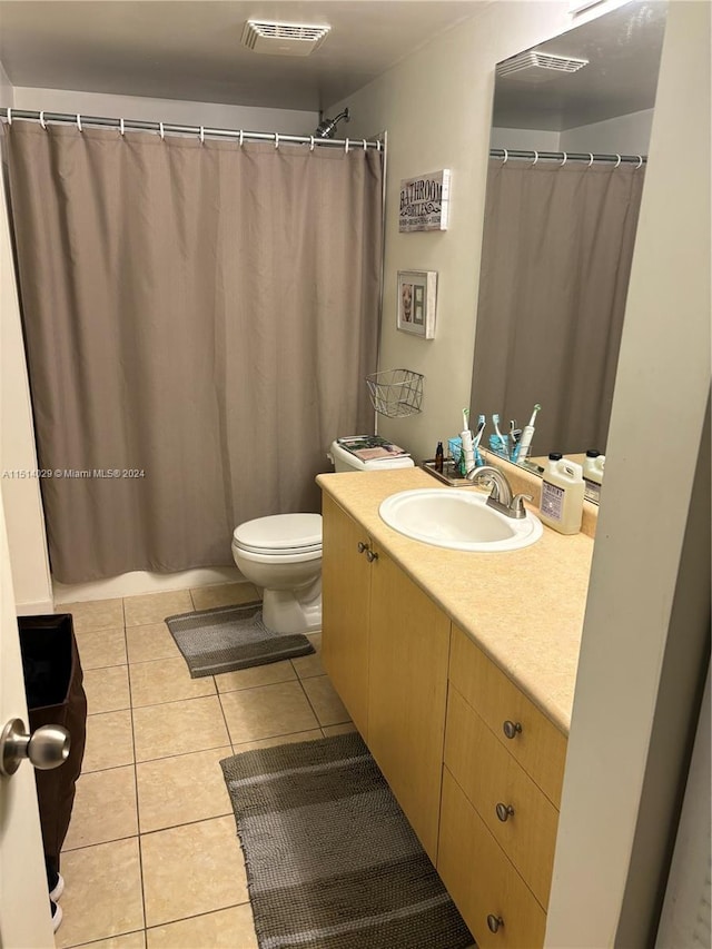 bathroom featuring tile patterned floors, toilet, and vanity