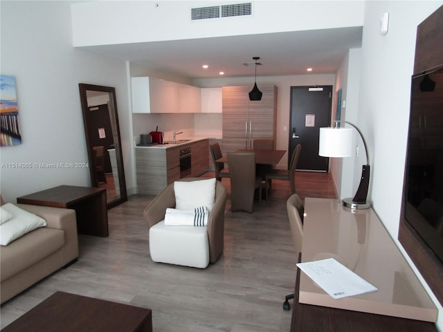 living room featuring light hardwood / wood-style floors and sink