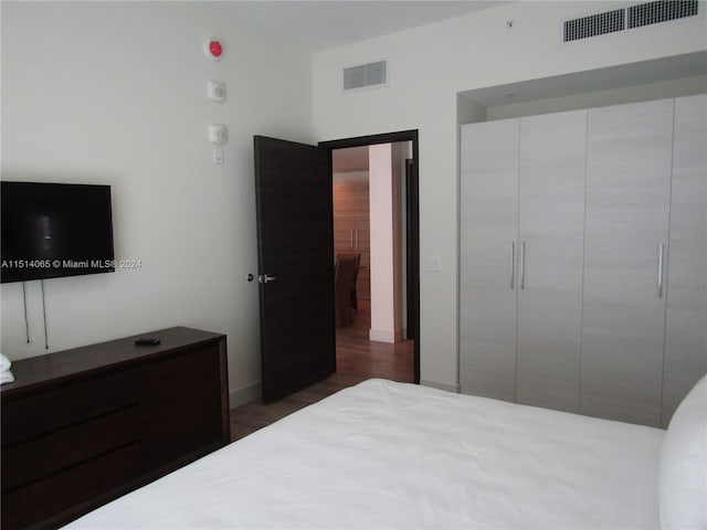 bedroom featuring a closet and dark wood-type flooring