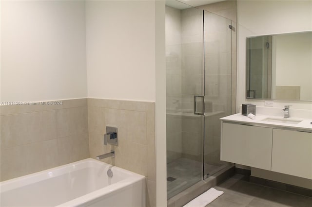 bathroom with vanity, plus walk in shower, and tile flooring